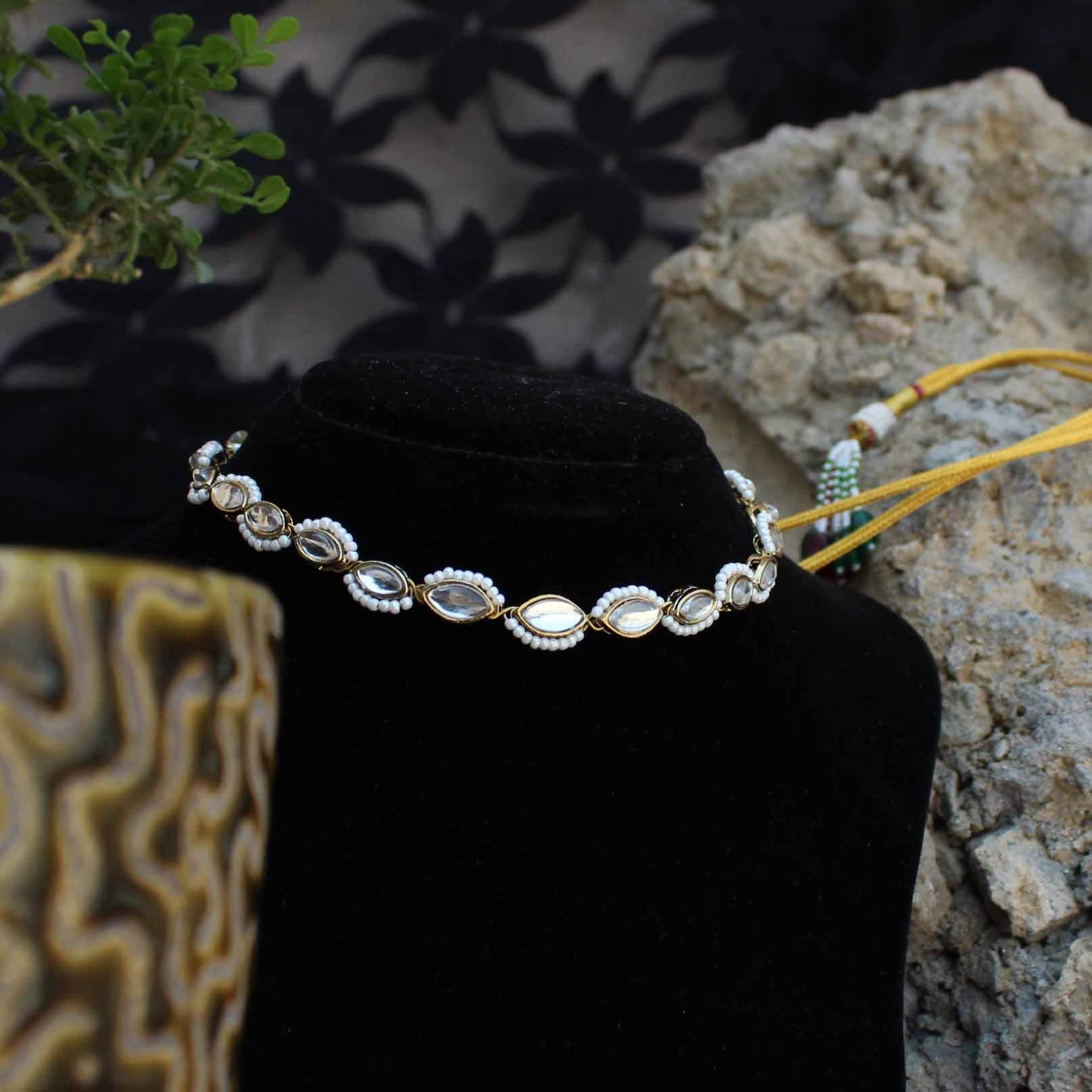Kundan choker set in gold-tone with matching earrings and long bridal necklace, perfect for wedding functions , festive and bridal wear