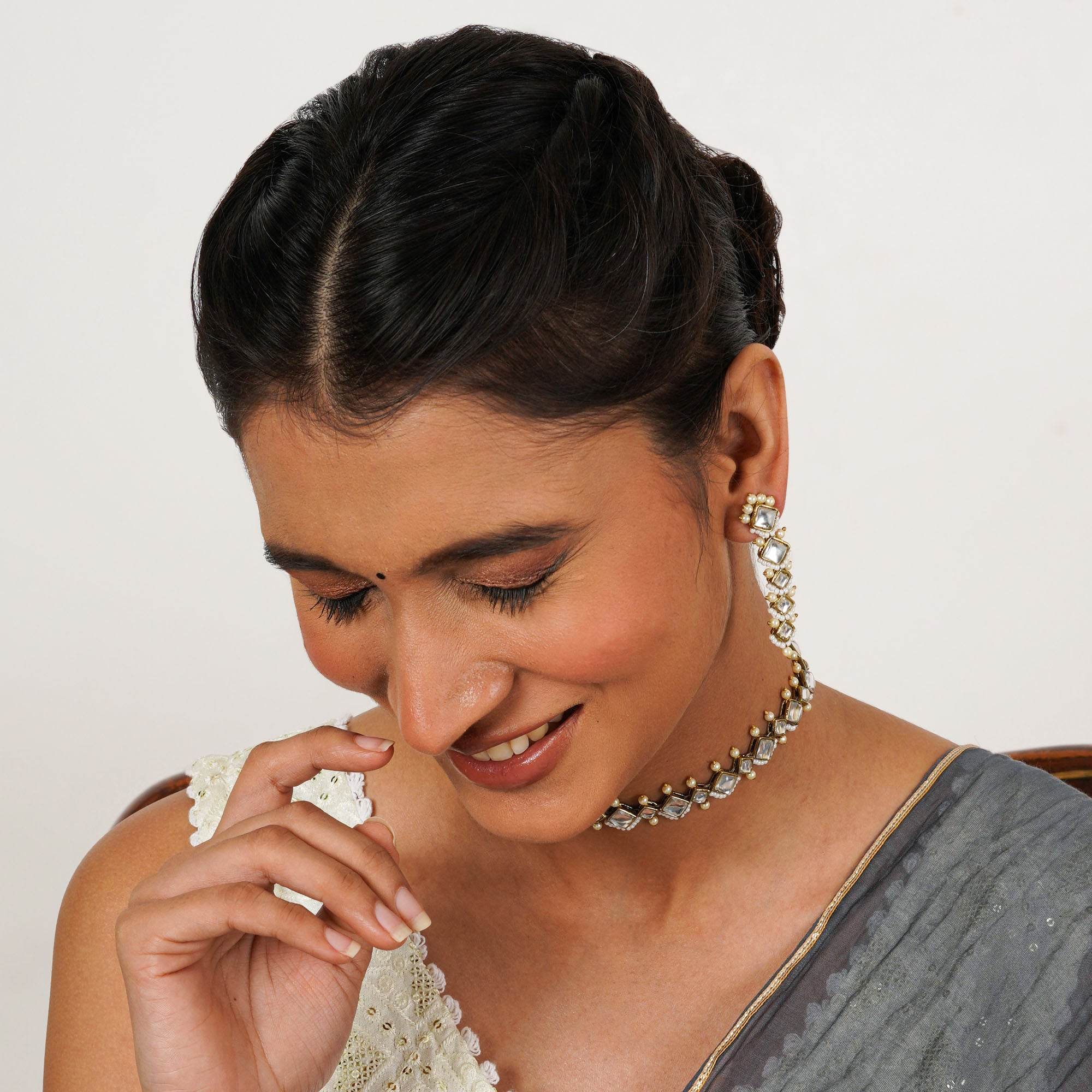 Kundan choker set in gold-tone with matching earrings and long bridal necklace, perfect for wedding functions , festive and bridal wear