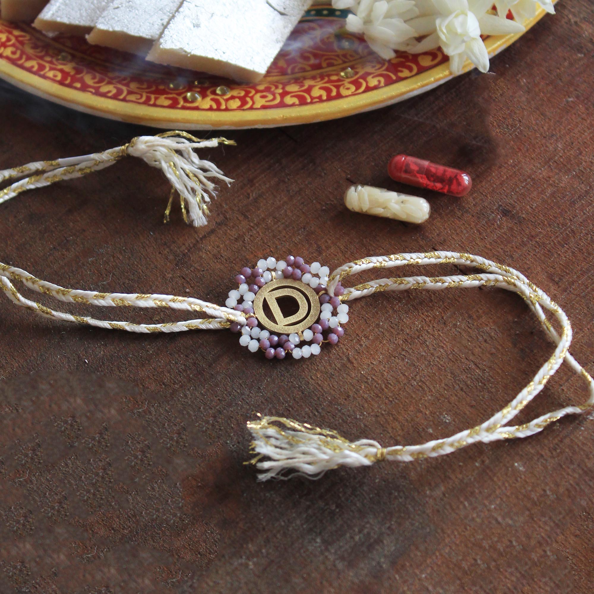 BeAbhika Purple Beads Gold Tone Personalised Name Initial Rakhi Customised Name Letter Alphabet Rakhi Lightweight Easy To Tie Rakhi Available At Best Price In India Online COD Available Send Rakhi To Brother Small Brother Big Brother Younger Brother Send Rakhi Abroad With Roli Chawal Capsules Designer Unqiue Famous