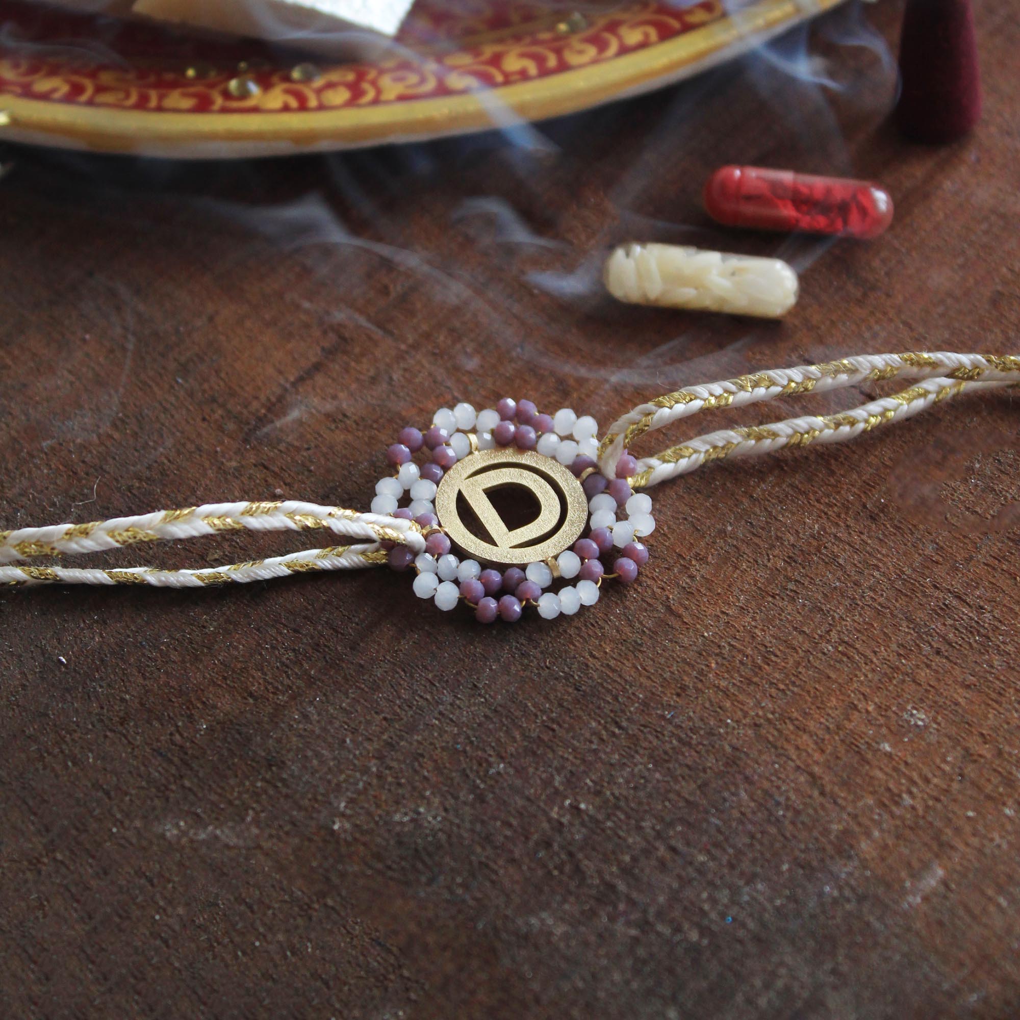 BeAbhika Purple Beads Gold Tone Personalised Name Initial Rakhi Customised Name Letter Alphabet Rakhi Lightweight Easy To Tie Rakhi Available At Best Price In India Online COD Available Send Rakhi To Brother Small Brother Big Brother Younger Brother Send Rakhi Abroad With Roli Chawal Capsules Designer Unqiue Famous