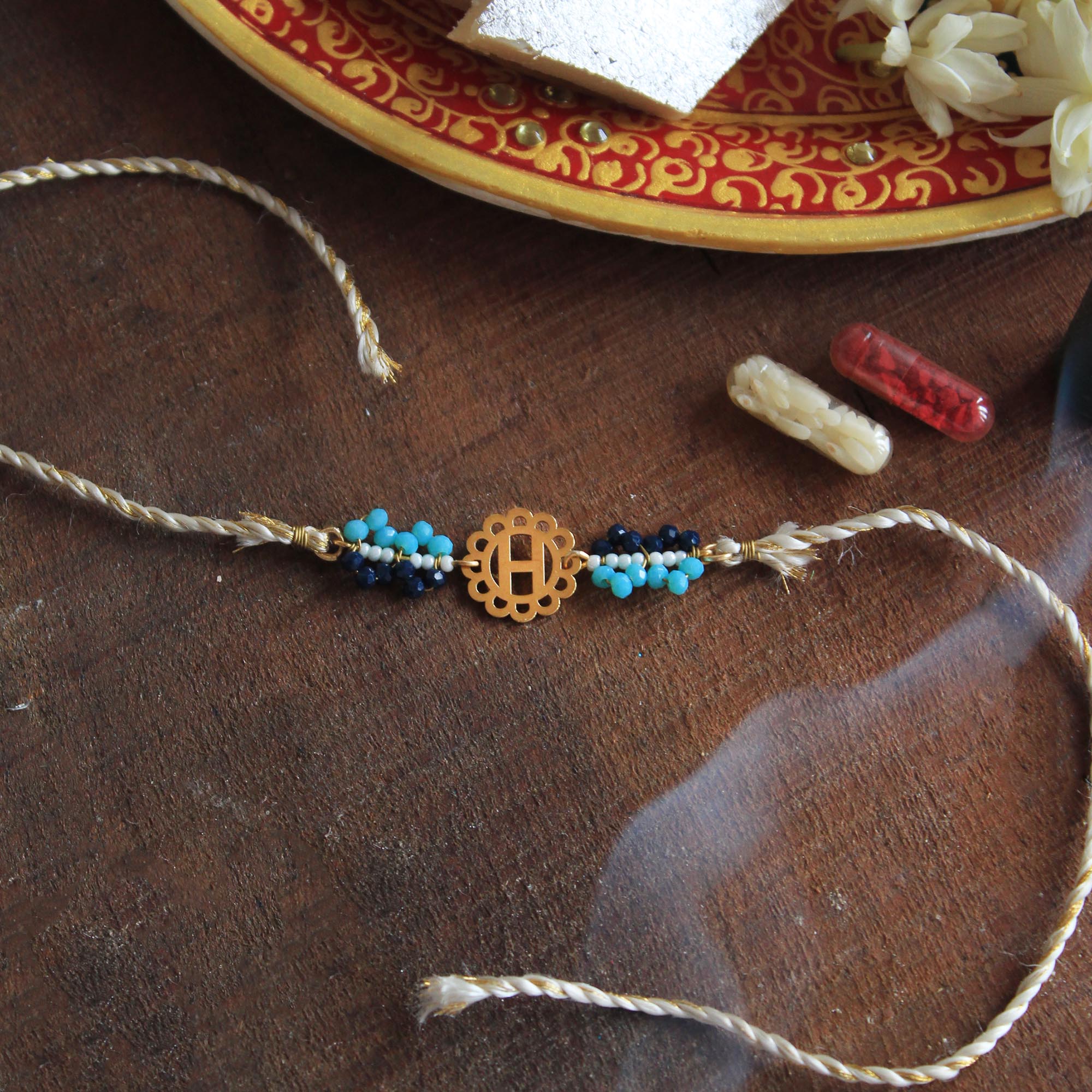BeAbhika Blue Beads Personalised Name Initial Rakhi Customised Name Letter Alphabet Rakhi Lightweight Easy To Tie Rakhi Available At Best Price In India Online COD Available Send Rakhi To Brother Small Brother Big Brother Younger Brother Send Rakhi Abroad With Roli Chawal Capsules Designer Unqiue Famous
