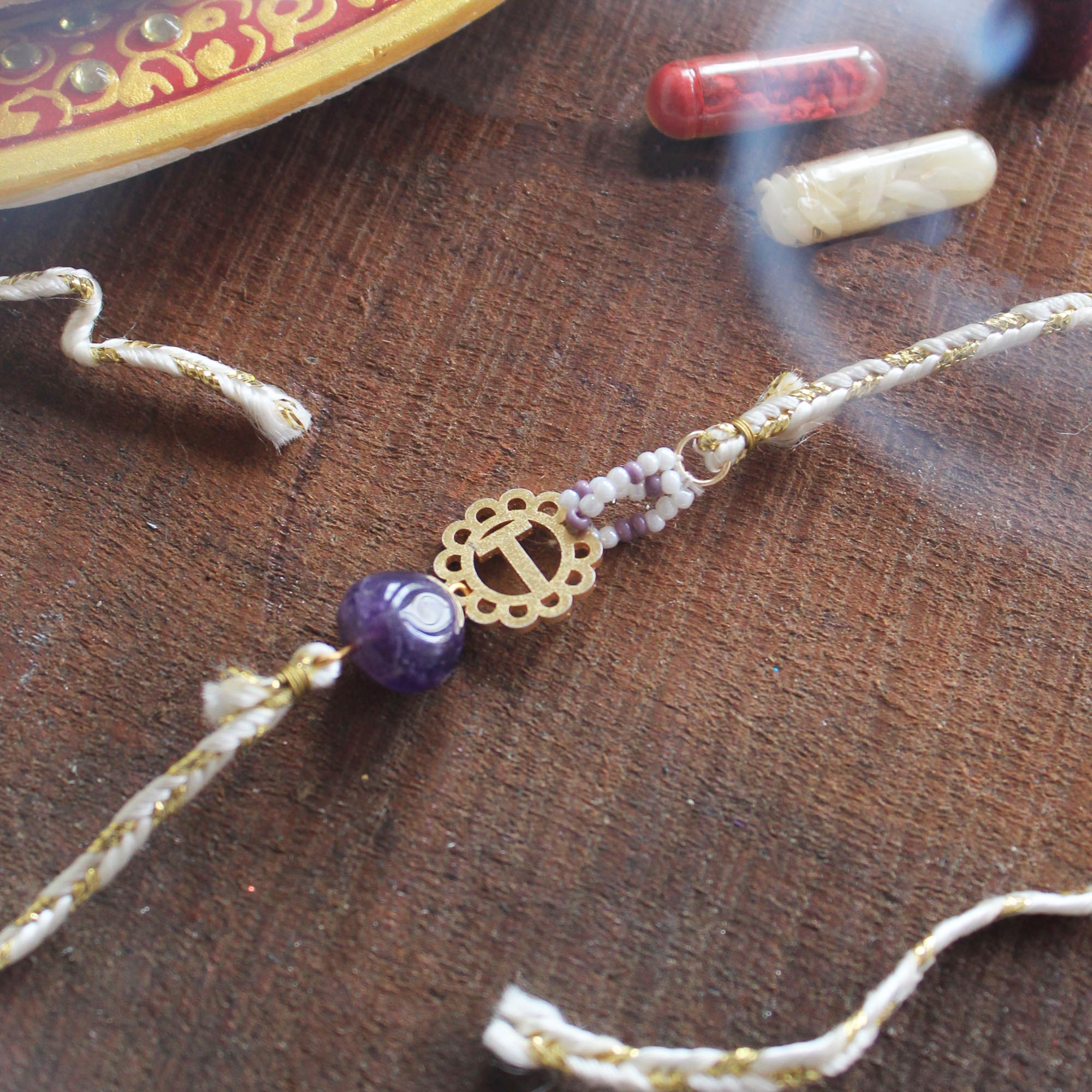 BeAbhika Gold Tone Rakhi Amaethyst Stone Purple Color Beads Lightweight Easy To Tie Rakhi Available At Best Price In India Online COD Available Send Rakhi To Brother Small Brother Big Brother Younger Brother Send Rakhi Abroad With Roli Chawal Capsules Designer Unqiue Famous