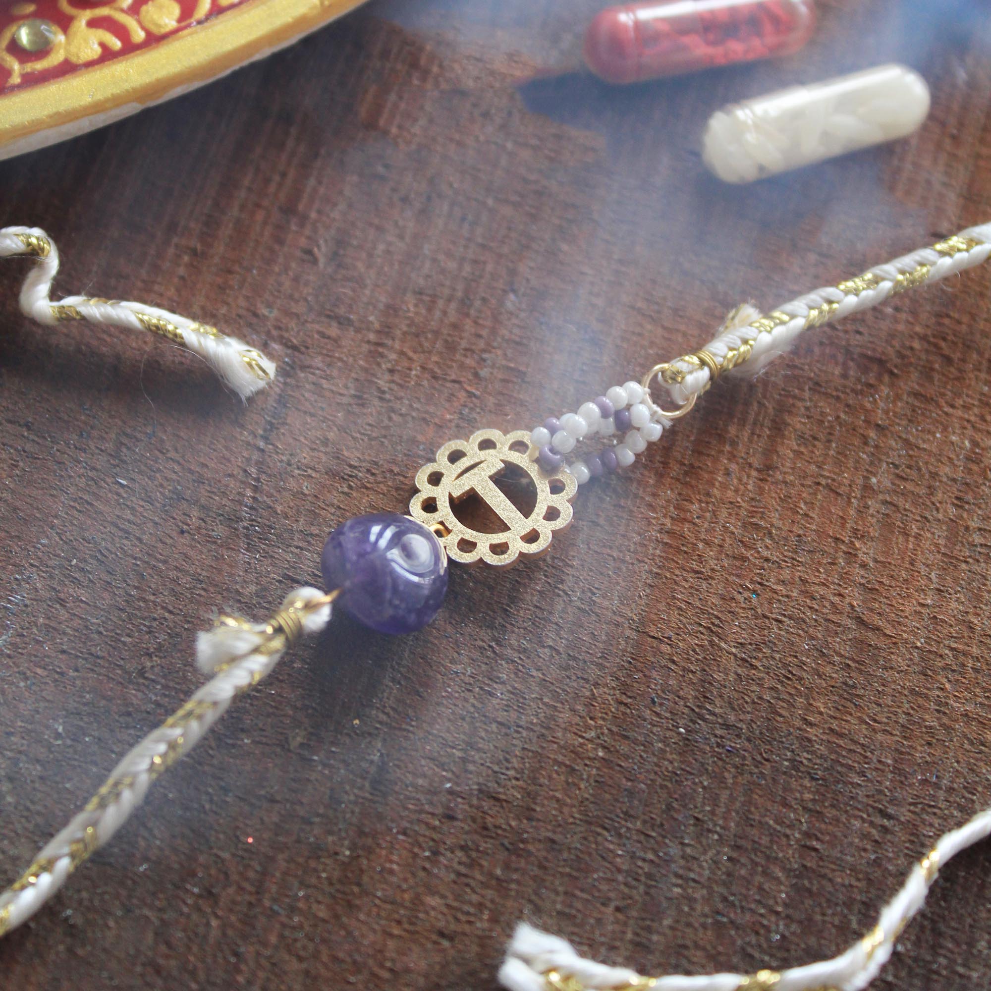 BeAbhika Gold Tone Rakhi Amaethyst Stone Purple Color Beads Lightweight Easy To Tie Rakhi Available At Best Price In India Online COD Available Send Rakhi To Brother Small Brother Big Brother Younger Brother Send Rakhi Abroad With Roli Chawal Capsules Designer Unqiue Famous