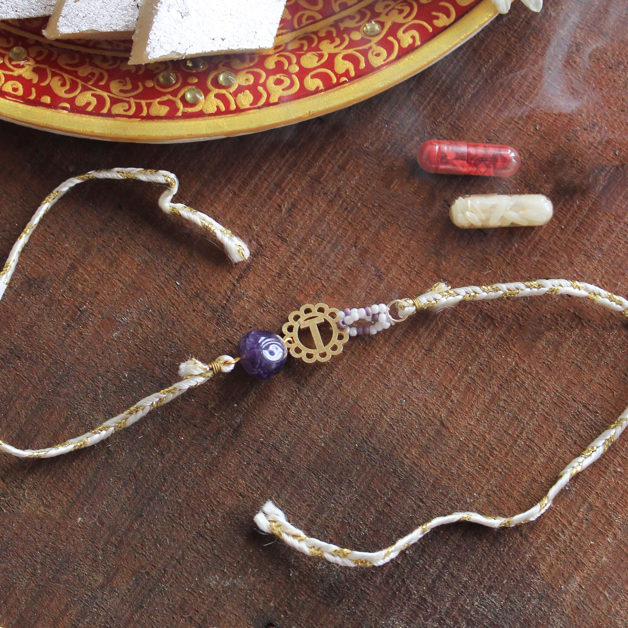 BeAbhika Gold Tone Rakhi Amaethyst Stone Purple Color Beads Lightweight Easy To Tie Rakhi Available At Best Price In India Online COD Available Send Rakhi To Brother Small Brother Big Brother Younger Brother Send Rakhi Abroad With Roli Chawal Capsules Designer Unqiue Famous