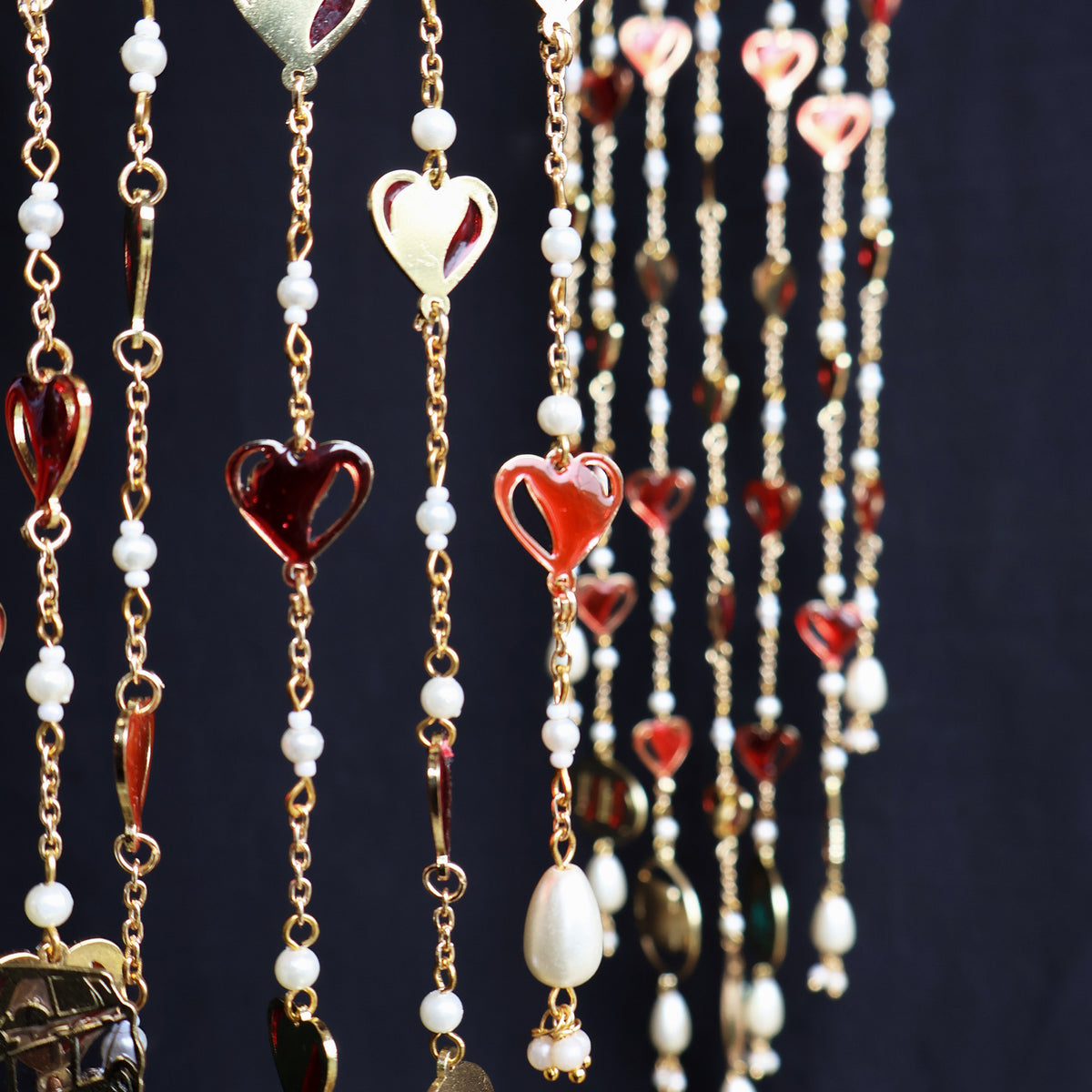 Romantic pearl Kaleere with red resin hearts charms, gold detailing and playful personalised charms  from the Darpan kalire collection by BeAbhika
