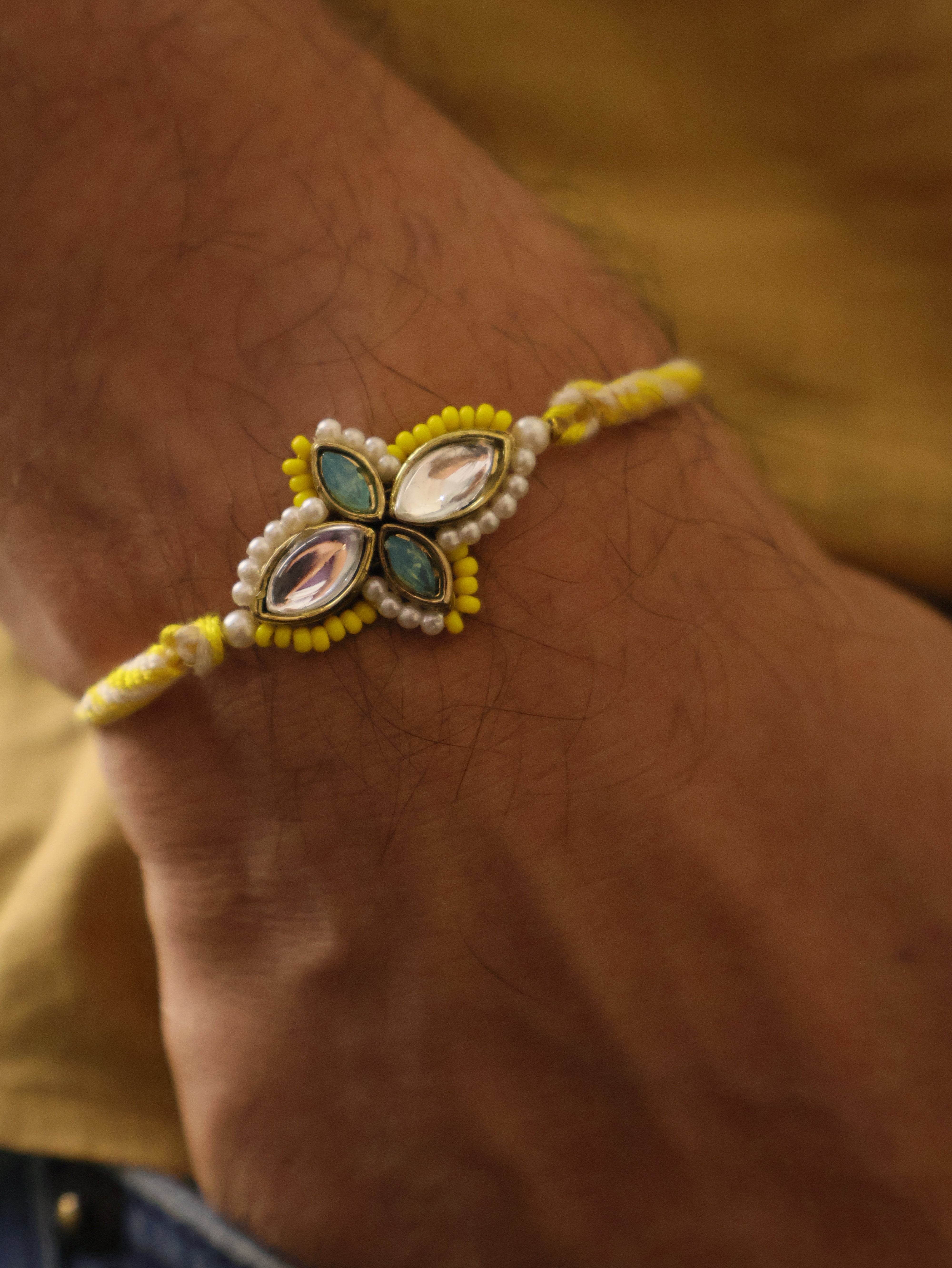 Yellow Kundan Floral Pearl Rakhi