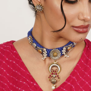 A richly detailed necklace where a textured braid meets intricate ornamental accents. The design feels expressive and thoughtfully layered, creating a piece that naturally draws the eye.