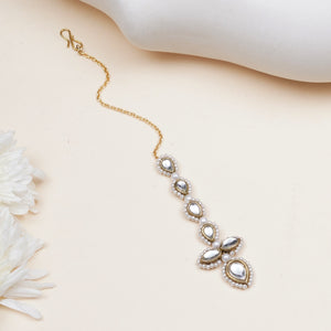 Floral Kundan maangtikka with pearl drop, featuring pear-shaped glass Kundan stones, white faux pearls and gold-tone alloy.
