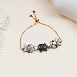 Navy blue bead bracelet with floral details, featuring glass Kundan stones, white faux pearls and gold-tone mixed alloy.