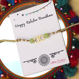 BeAbhika Green Pearl Personalised Initial Rakhi Gold Tone Lightweight Easy To Tie Customised Name Letter Rakhi Available At Best Price In India Online COD Available Send Rakhi To Brother Small Brother Big Brother Younger Brother Send Rakhi Abroad With Roli Chawal Capsules Designer Unqiue Famous 