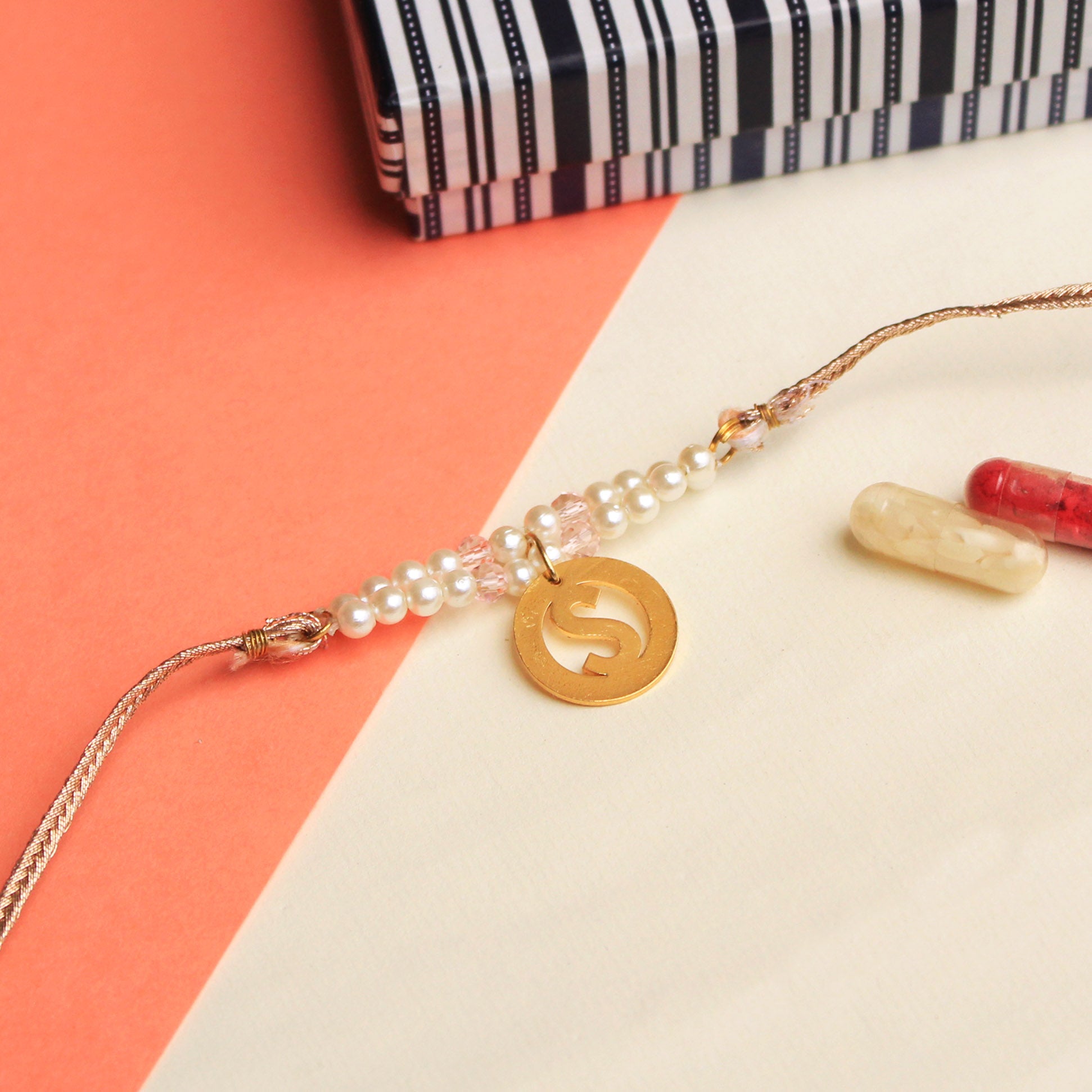 BeAbhika White Peach Pearl Personalised Initial Rakhi Gold Tone Lightweight Easy To Tie Customised Name Letter Rakhi Available At Best Price In India Online COD Available Send Rakhi To Brother Small Brother Big Brother Younger Brother Send Rakhi Abroad With Roli Chawal Capsules Designer Unqiue Famous 