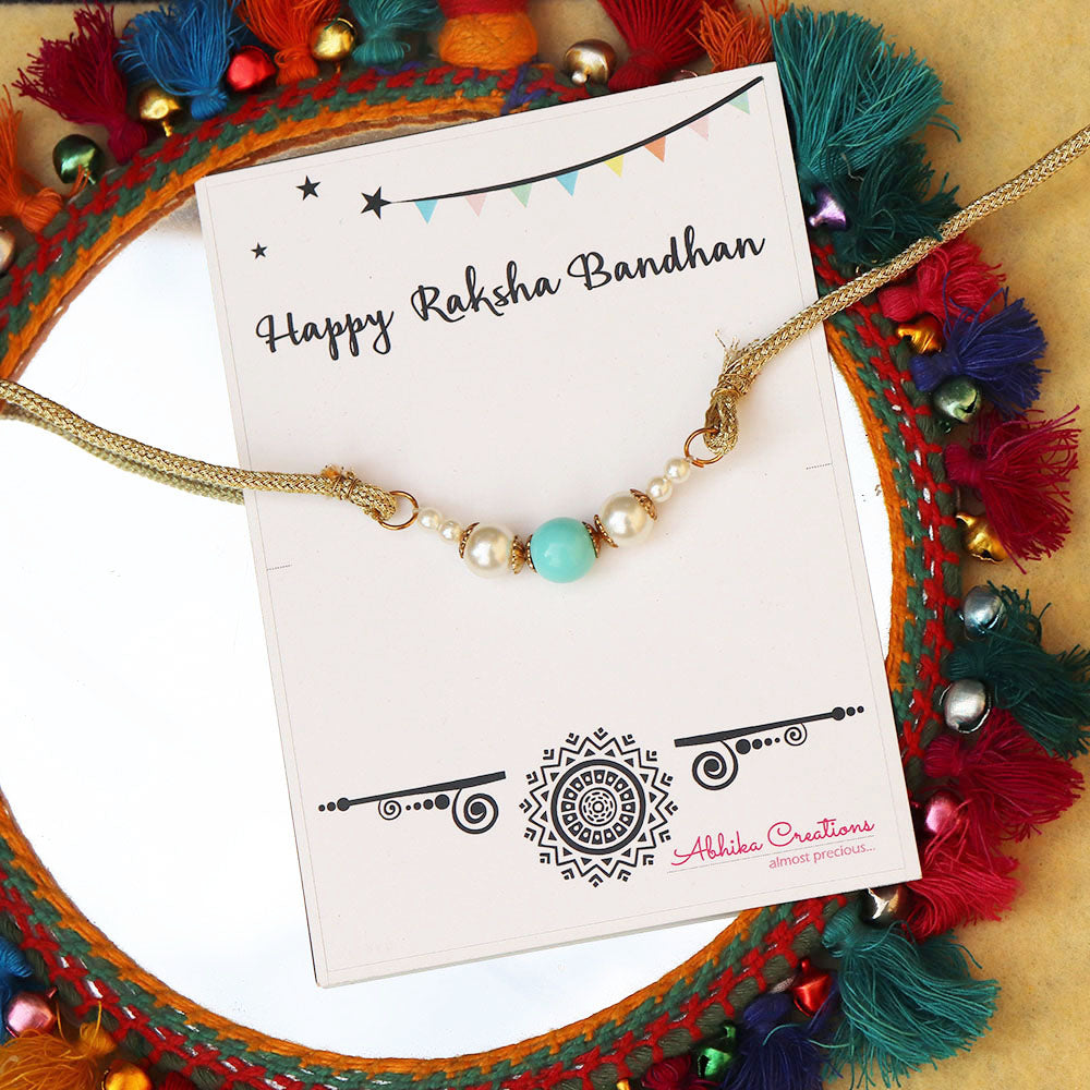 BeAbhika Blue Beads White Pearls Gold Tone Rakhi Special Designer Handmade Unique Bhai Rakhi Available In India Online At Best Price Send Rakhi To Brother COD Available Express Shipping