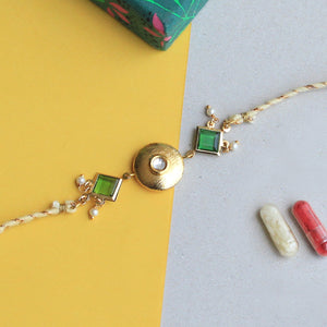 BeAbhika Green Stone Brass Golden Rakhi Gold Tone Lightweight Easy To Tie Rakhi Available At Best Price In India Online COD Available Send Rakhi To Brother Small Brother Big Brother Younger Brother Send Rakhi Abroad With Roli Chawal Capsules Designer Unqiue Famous 