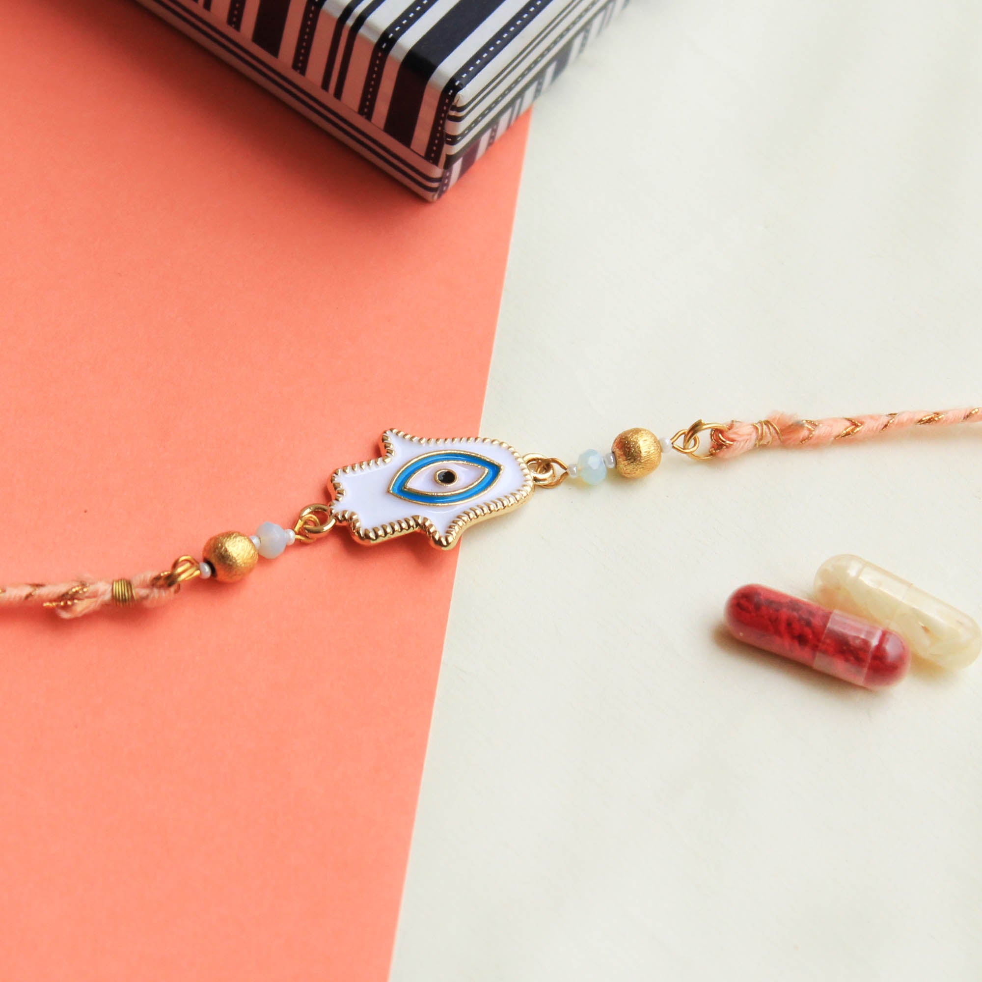 BeAbhika Hamsa Evil Eye Blue White Rakhi  Brass Thread Rakhi Available At Best Price In India Online COD Available Send Rakhi To Brother For Small Brother Big Brother Younger Brother Send Rakhi Abroad With Roli Chawal Capsules Designer Unqiue Famous 