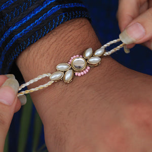 BeAbhika White Pearl Rakhi Gold Tone Pink Beads Lightweight Easy To Tie Rakhi Available At Best Price In India Online COD Available Send Rakhi To Brother For Small Brother Big Brother Younger Brother Send Rakhi Abroad With Roli Chawal Capsules Designer Unqiue Famous 