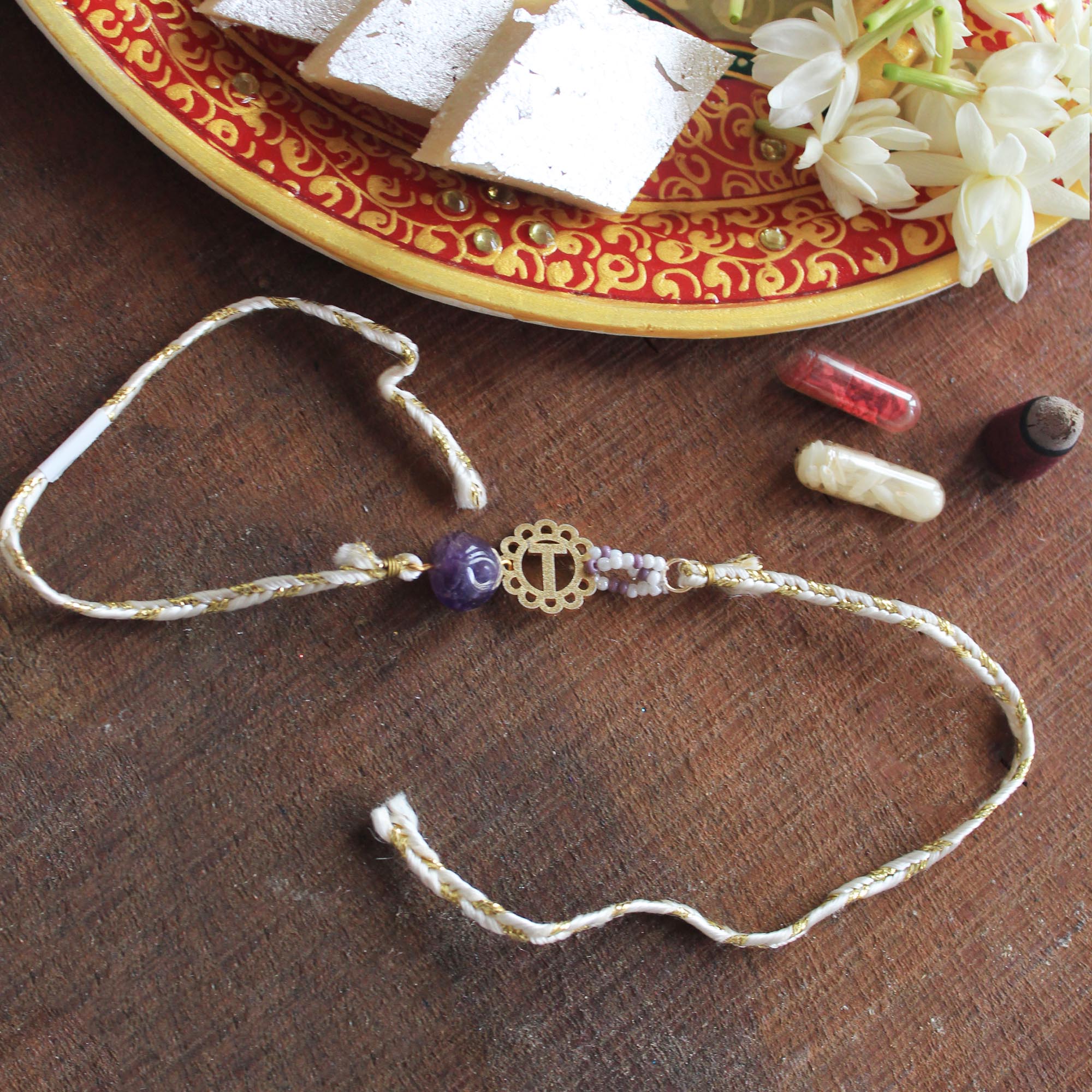 BeAbhika Gold Tone Rakhi Amaethyst Stone Purple Color Beads Lightweight Easy To Tie Rakhi Available At Best Price In India Online COD Available Send Rakhi To Brother Small Brother Big Brother Younger Brother Send Rakhi Abroad With Roli Chawal Capsules Designer Unqiue Famous 
