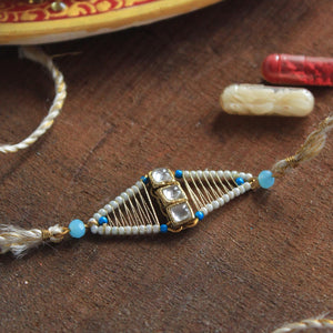 BeAbhika Blue Beads Golden Tone Kundan Rakhi Designer Unqiue Famous Rakhi Lightweight Easy To Tie Rakhi Available At Best Price In India Online COD Available Send Rakhi To Brother Small Brother Big Brother Younger Brother Send Rakhi Abroad With Roli Chawal Capsules