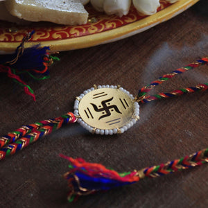 BeAbhika Gold Tone Swathik Design White Beads Religious Swastik Rakhi Designer Unqiue Famous Rakhi Lightweight Easy To Tie Rakhi Available At Best Price In India Online COD Available Send Rakhi To Brother Small Brother Big Brother Younger Brother Send Rakhi Abroad With Roli Chawal Capsules