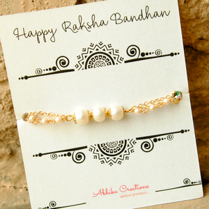 BeAbhika White Pearl Rakhi Gold Tone Lightweight Easy To Tie Rakhi Available At Best Price In India Online COD Available Send Rakhi To Brother For Small Brother Big Brother Younger Brother Send Rakhi Abroad With Roli Chawal Capsules Designer Unqiue Famous 